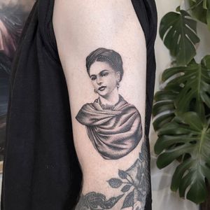 Stunning black and gray upper arm tattoo of Frida Kahlo by Martin Rosenberg, capturing her iconic beauty in intricate detail.