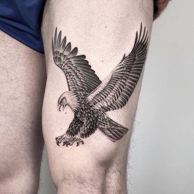 Get a striking black and gray eagle tattoo by Martin Rosenberg on your upper leg for a powerful and bold statement.