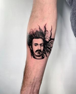 Get a stunning lower arm tattoo of Frank Zappa in micro realism style by Martin Rosenberg.