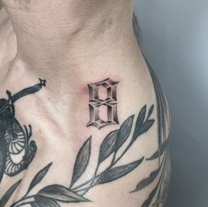 Unique shoulder tattoo combining dotwork, fine line, and lettering by artist Martin Rosenberg.