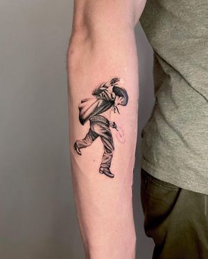Get ready for a cowboy standoff with this stunning black and gray fine line tattoo on your lower arm by Martin Rosenberg.