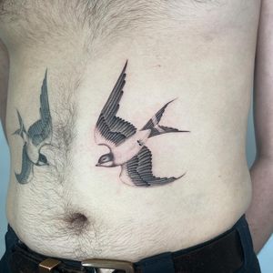 Elegant black and gray fine line swallow tattoo by Martin Rosenberg adds a touch of sophistication to your body art collection.