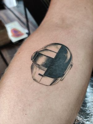 Unique blackwork tattoo of a Daft Punk helmet on the forearm, designed by Mary Shalla.