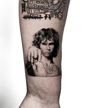 Detailed black and gray portrait of Jim Morrison by Jay Soze, perfect for any music lover's forearm.