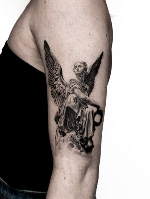 Stunning black and gray tattoo of angel wings on upper arm by Jay Soze. Achieve a heavenly look with this intricate design.