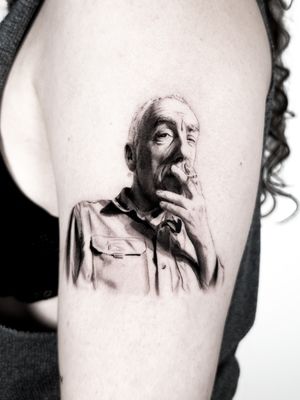Capture a loved one's likeness with this striking black and gray portrait tattoo by Jay Soze. Expertly rendered in a realistic style.