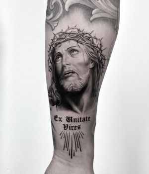 Intricate design by Jay Soze on upper leg with detailed micro-realism Jesus and lettering motif