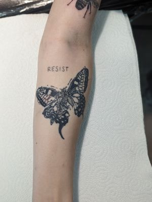 George Antony's black and gray butterfly tattoo on forearm exudes grace and sophistication.