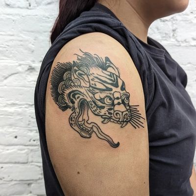 Experience traditional Japanese art with this stunning dog motif tattoo by George Antony on your upper arm.