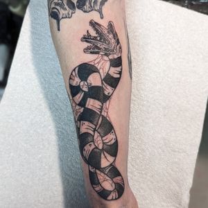 Capture the beauty of nature with this neo traditional snake tattoo on your lower leg by the talented artist George Antony.