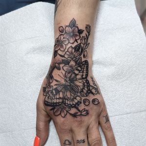 Beautiful butterfly and flower design by George Antony, elegantly done in black and gray ink on the hand.