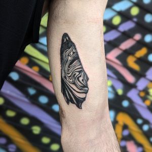 Experience the haunting beauty of George Antony's blackwork ghost motif tattoo design on your upper arm. Perfect for those seeking a unique and mysterious tattoo.