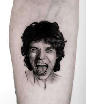 Capture Mick Jagger's iconic likeness with this black and gray realism tattoo by Jay Soze on your forearm.