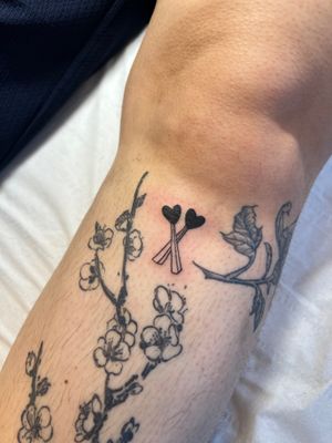 Ignorant style tattoo by Kayleigh Cole featuring hearts and matches, perfect for the shin area.