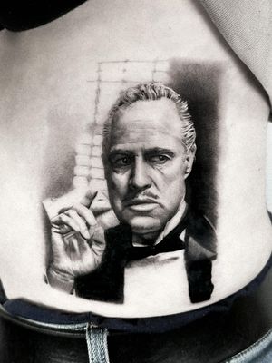 Stunning black and gray micro-realism portrait of the Godfather on the stomach by Jay Soze. 