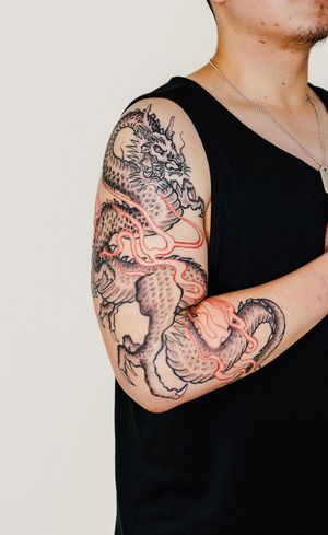 Get a striking and intricate Japanese dragon sleeve tattoo by Gabriele Edu, showcasing the power and beauty of this mythical creature.