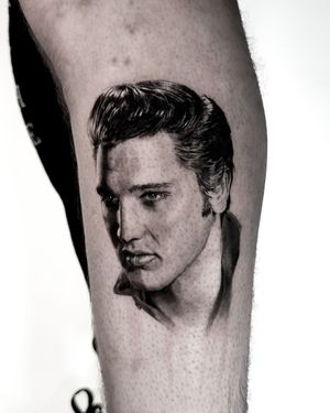 Detailed black and gray tattoo of Elvis Presley's portrait on the arm, created with precision by artist Jay Soze.