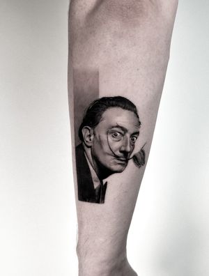 Meet Salvador Dali on your lower arm with this stunning black and gray micro realism tattoo by Jay Soze.