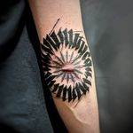 Elegantly combining intricate patterns and bold lettering for a striking and meaningful design on the elbow.