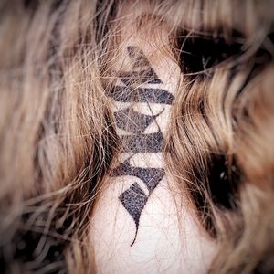 Elegant lettering and intricate patterns come together in this stunning blackwork neck tattoo by talented artist Chun Lee.