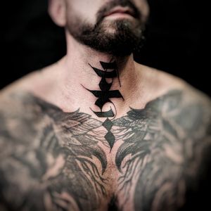 Get a unique lettering tattoo with a stylish pattern design on your neck by the talented artist Chun Lee. Stand out with this bold and artistic tattoo!