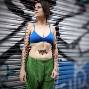 Elegant lettering tattoo featuring a meaningful quote by Chun Lee, beautifully inked on the stomach. Perfect for a daily reminder or personal mantra.