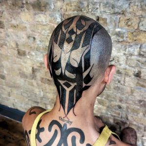 Exquisite blackwork design by Chun Lee for a bold tribal pattern on the side of your face. Make a statement with this striking tattoo.