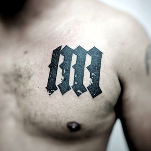 Unique blackwork design by Chun Lee featuring intricate pattern and bold lettering on the chest.