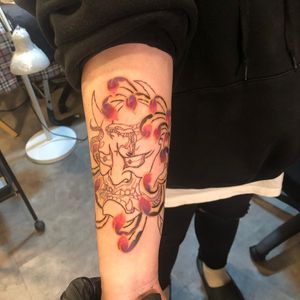 Experience the beauty and power of Japanese art with this stunning forearm tattoo featuring chrysanthemum and Hannya motifs. By talented artist Hansol Jung.