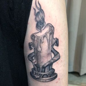 Capture the flickering essence of a candle with this black and gray trashpolka upper arm tattoo by Hansol Jung.