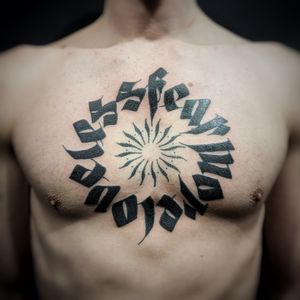 Get a unique blackwork tattoo featuring a patterned quote on your chest by Chun Lee.