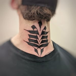 A bold blackwork tribal pattern tattoo by Chun Lee on the neck, showcasing intricate designs and strong geometric shapes.