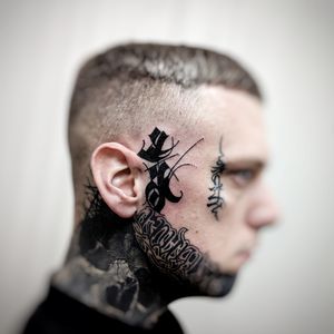 Embrace the boldness of blackwork tribal lettering with a unique side face pattern design by artist Chun Lee.