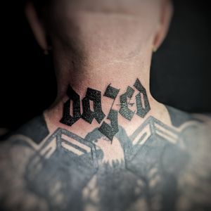 Express yourself with bold black lettering on your neck by tattoo artist Chun Lee. Let your mantra shine through in style.