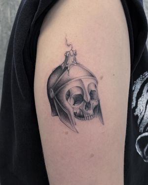 Get a striking black and gray upper arm tattoo of a skull and candle, by the talented artist Fresh Flower.