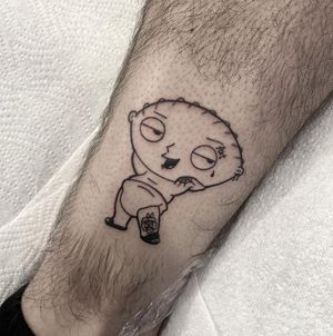 Get a vibrant new school style tattoo of Stewie from Family Guy on your ankle, done by the talented artist Federico Colantoni.