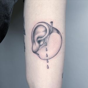 Get a stunning black and gray tattoo of an apple and ear on your forearm by Fresh Flower, perfect for a unique and artistic design.