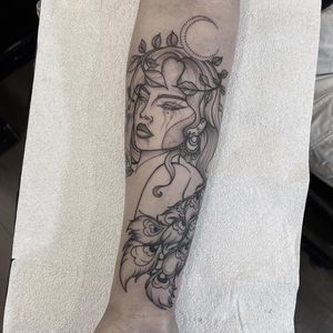 Elegant forearm tattoo by Federico Colantoni featuring a delicate peacock and woman design in fine line style.