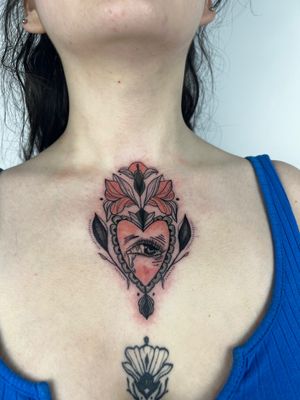 Adorn your chest with a stunning neo-traditional tattoo featuring a beautiful flower and eye motif by Kiky Flore.