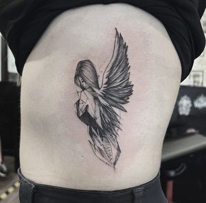 Experience the divine with this striking black and gray angel tattoo by Federico Colantoni. Perfect for stomach placement.