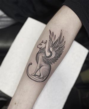 Beautiful dotwork and fine line forearm tattoo of a cat with wings, created by Federico Colantoni.