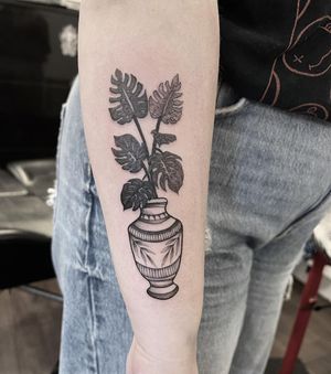 Elegant black and gray vase tattoo on the arm, skillfully done by artist Federico Colantoni.