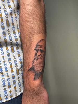 Check out this stunning black and gray man tattoo on the lower arm by Kiky Flore. Detailed and realistic design.