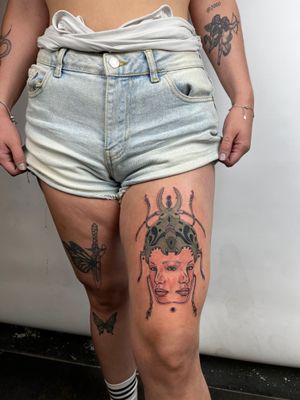 Stunning upper leg tattoo by Kiky Flore featuring a beetle and portrait in a neo-traditional style.