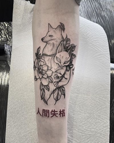 Small lettering forearm tattoo of a fox and kanji symbols by Federico Colantoni, showcasing intricate fine line work.