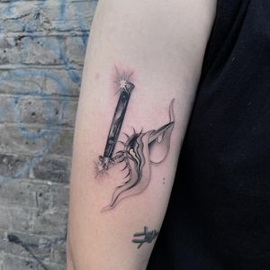 Express your inner darkness with a surreal black and gray tattoo on your arm, featuring a knife and eye by Fresh Flower.