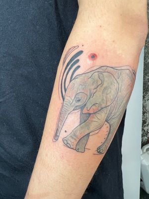 Capture the beauty of an elephant in delicate fine lines and vibrant watercolor hues on your lower arm. Designed by Kiky Flore.
