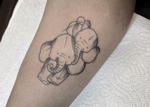 Experience the intricate beauty of Federico Colantoni's fine line elephant design on your forearm.
