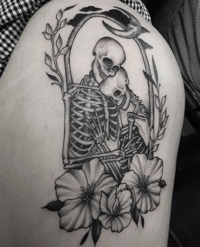 Adorn your upper leg with Elisa Thirteen's stunning black and gray tattoo featuring a beautiful flower intertwined with a skeletal figure, symbolizing the eternal connection between love and mortality.