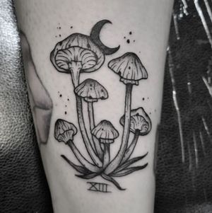 Experience the magic with this black and gray tattoo by Elisa Thirteen, featuring moon, mushroom, roman numerals, and shrooms. Perfect for small lettering lovers.